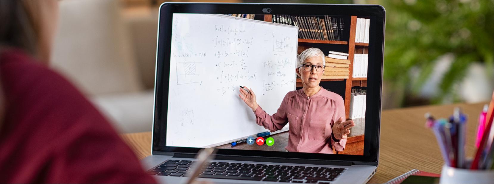  Person attending an online class on a laptop